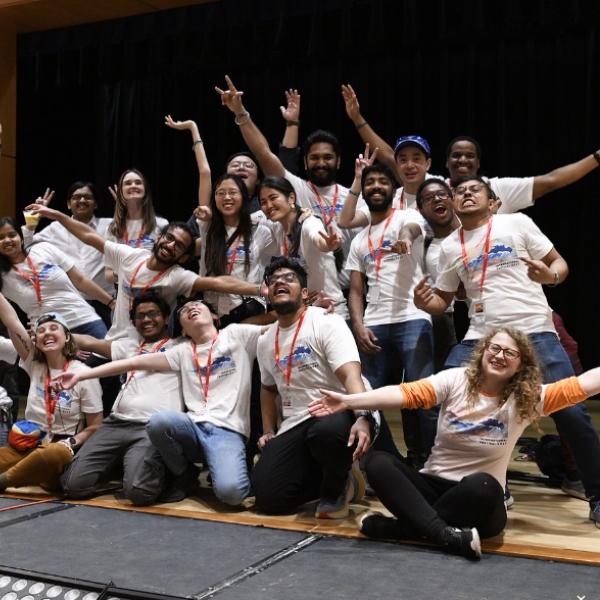 ifest committee together on a stage