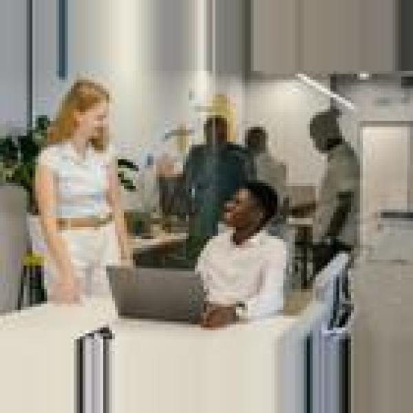 Photo of two people talking in a work setting