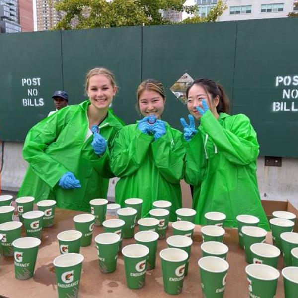 Three volunteers at a race water table