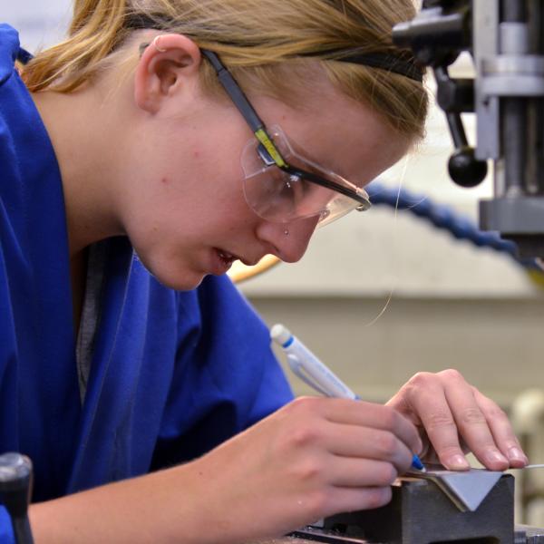 girl looking through a microscope
