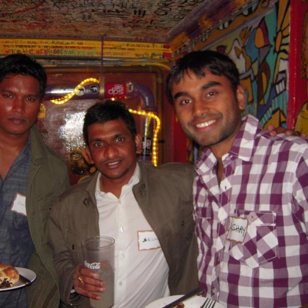 Three BFIS students in front of restaurant mural