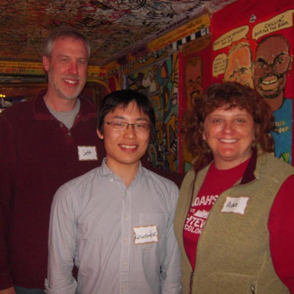 BFIS family and student in front of restaurant mural