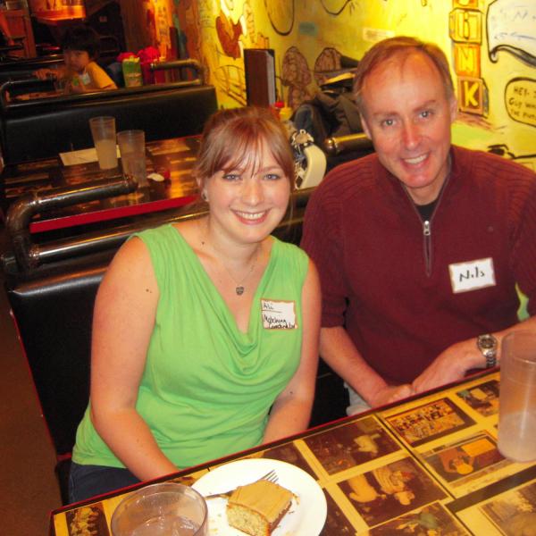 BFIS board member and student sitting at restaurant booth