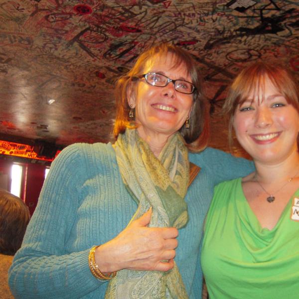 BFIS coordinator with student under colorful restaurant ceiling
