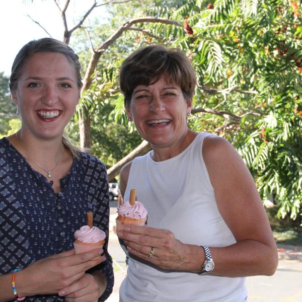 BFIS member and student smiling with fancy cupcakes