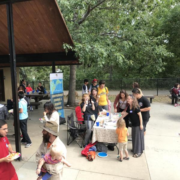 View of the check-in table and several picnic attendees hanging out
