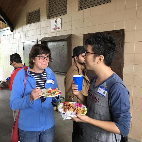 BFIS woman eating next to student