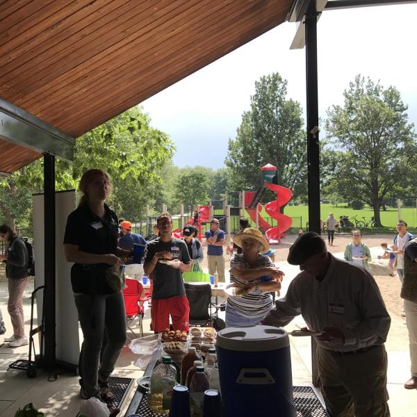 ISSS staff standing on picnic table to make announcements as others gather around