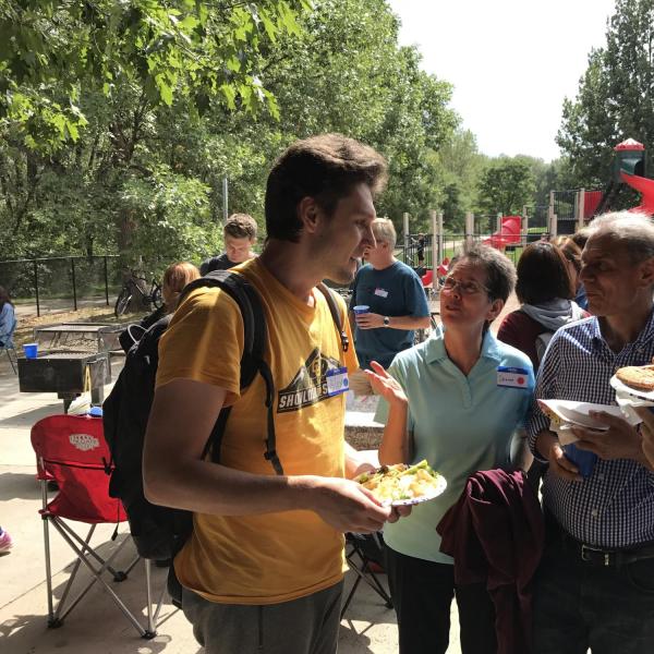 Two students talking to two BFIS family members