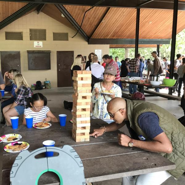 People gathered around the jenga game