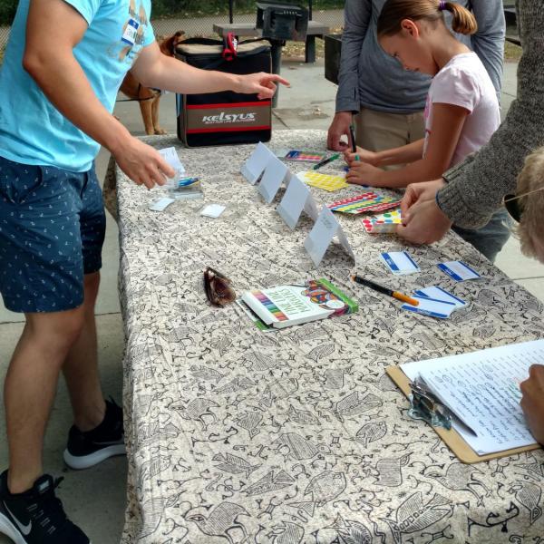 International student guide checking people in at the welcome table