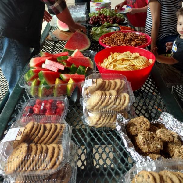 Family grabbing food from the food table