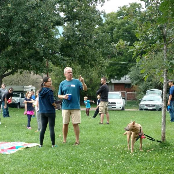 BFIS man, student, and dog on grassy field