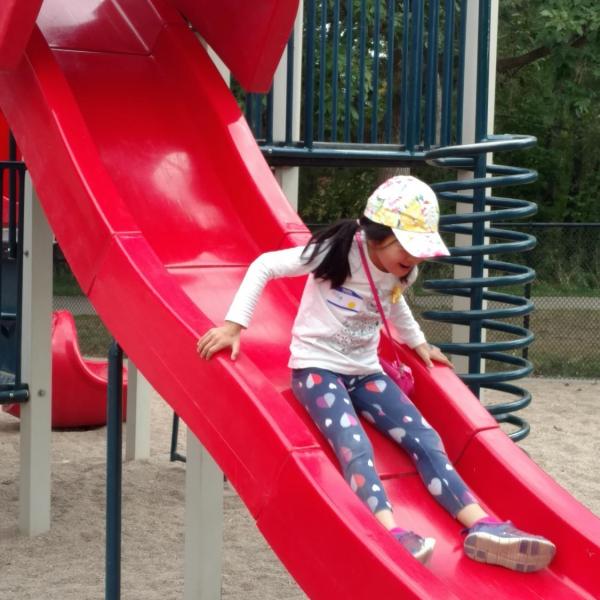 Girl on red slide