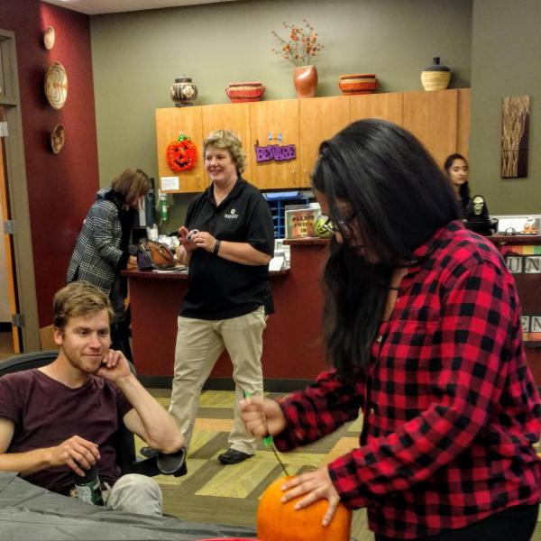 Student giving a pumpkin carving demonstration