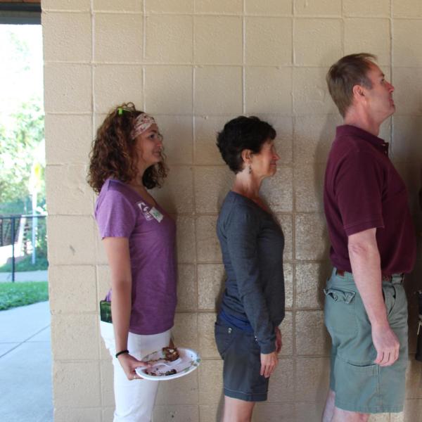 BFIS board members standing in a line up fashion against the wall