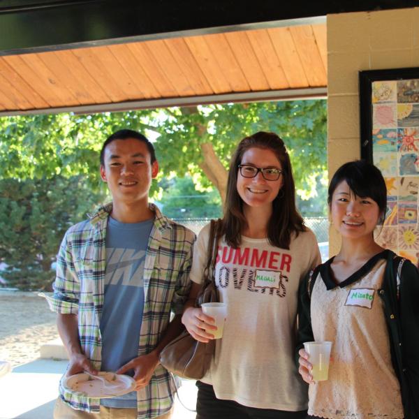 Four BFIS students smiling under picnic shelter