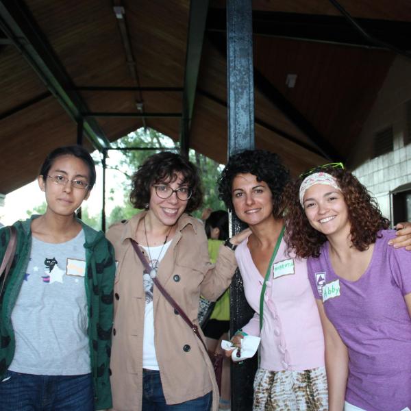 Four BFIS members smiling under picnic shelter