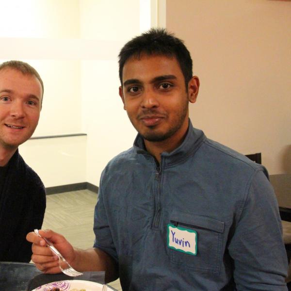Two BFIS students eating at table