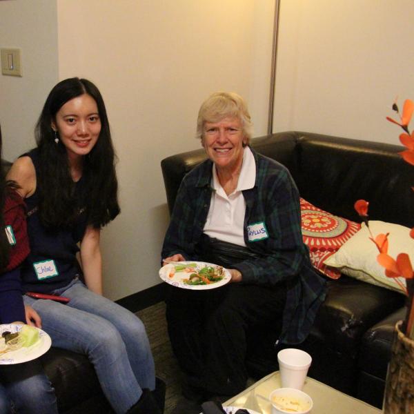 Thre BFIS members smiling with food from comfy chairs