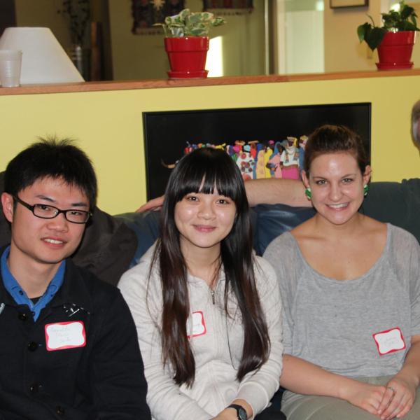 BFIS students sitting on couch with their BFIS family