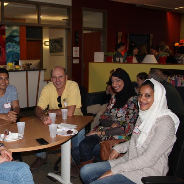 Five BFIS members sitting around table smiling