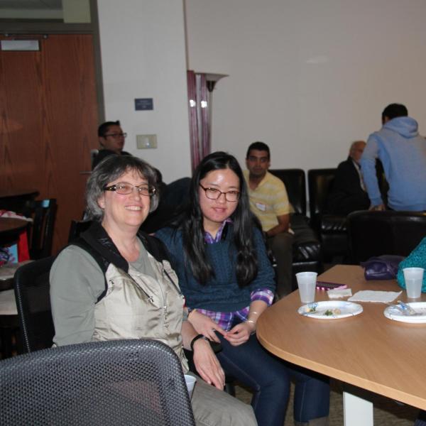 Four BFIS members sitting around table smiling