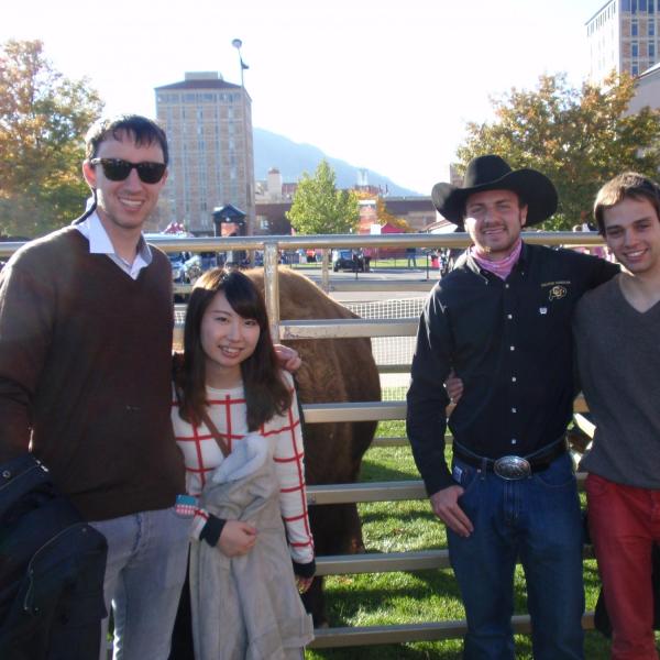 Three BFIS members with a Ralphie handler in front of Ralphie