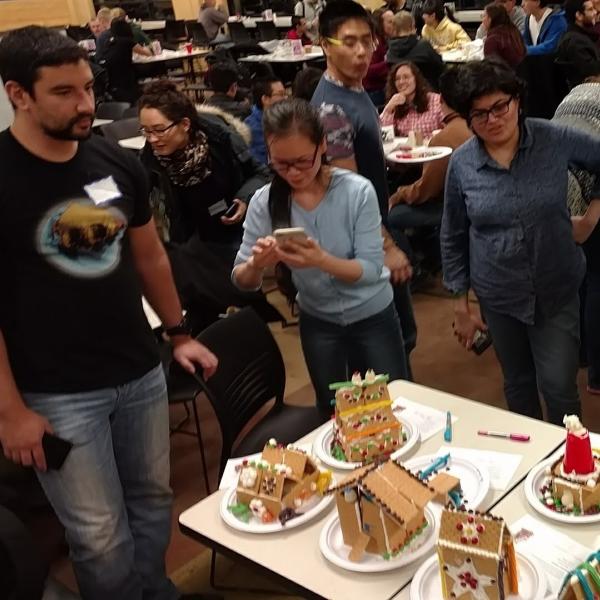 People looking at finished gingerbread houses