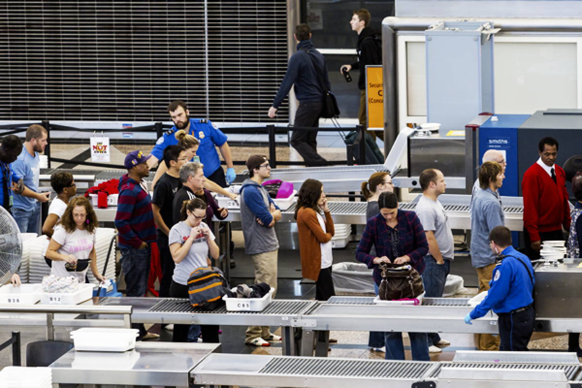 People in line going through airport security screening