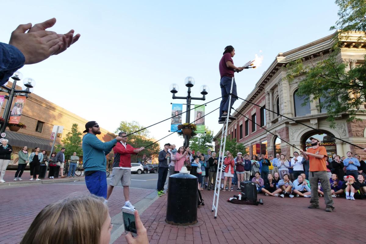 a crowd watching a street performer