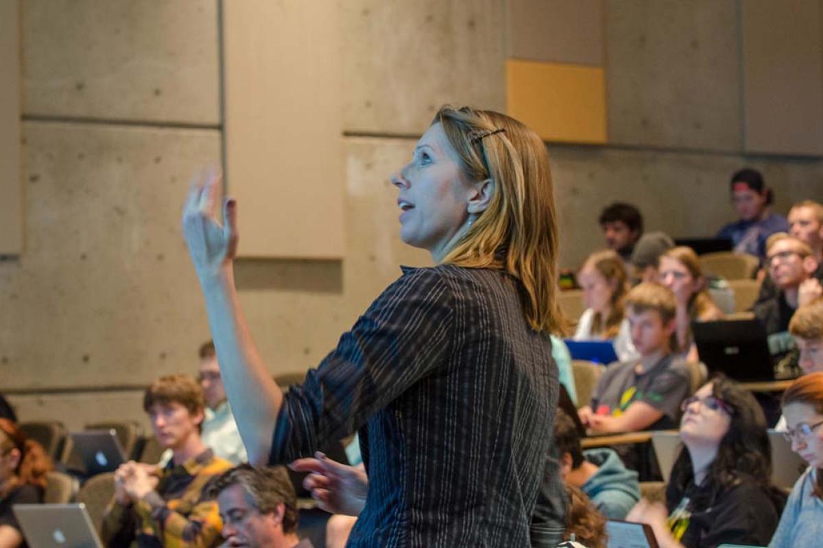 teacher in front of a large full lecture hall