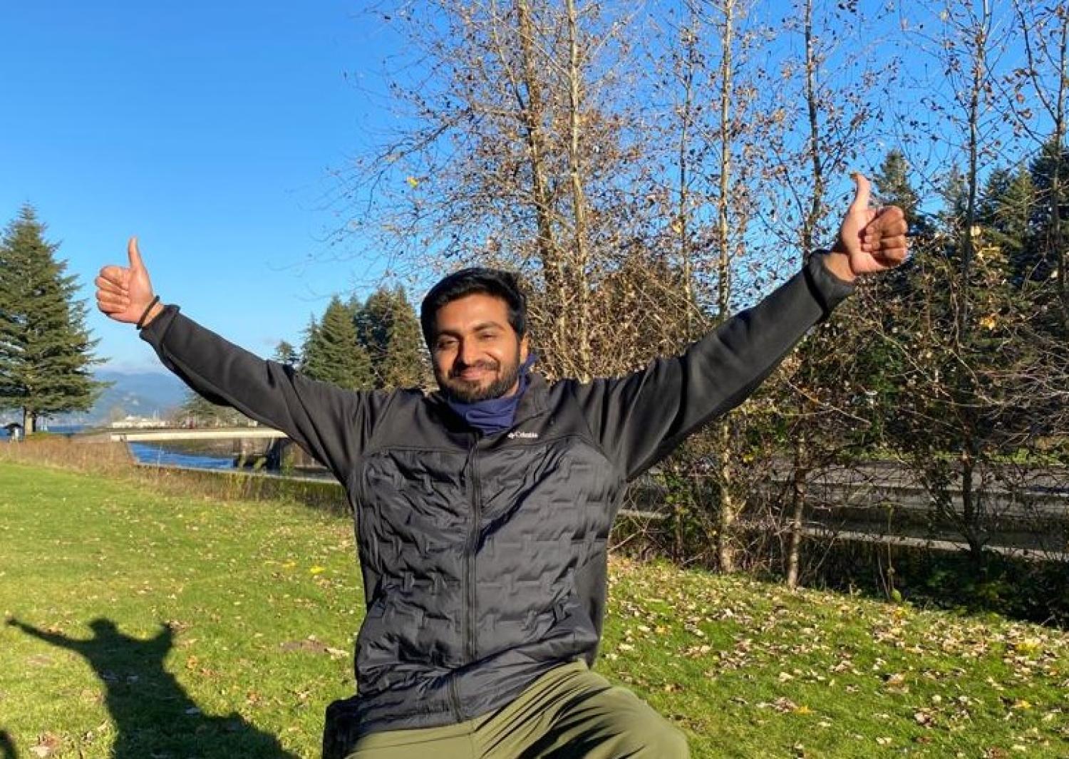 Picture of Rayshan giving a thumbs up in a field