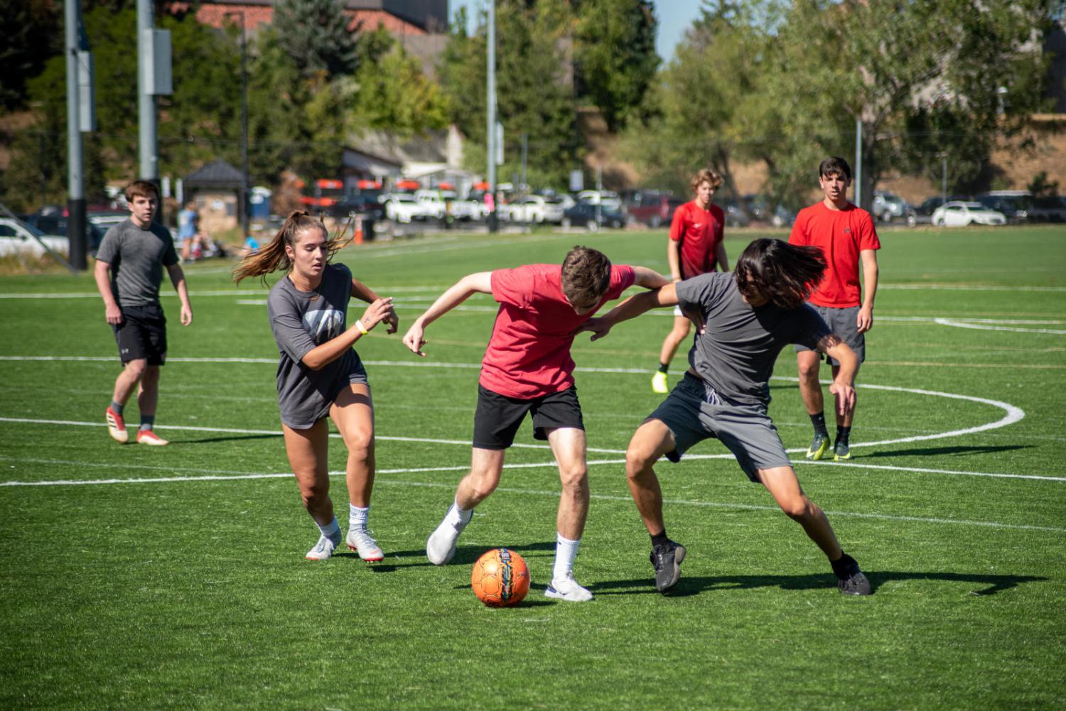 students playing soccer outside