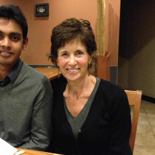 Student with his BFIS host parent smiling at a table