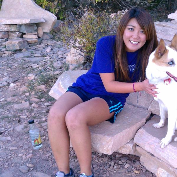 BFIS student and dog sitting on rocky trail