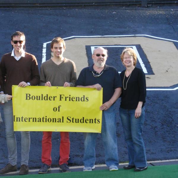 BFIS family and students on football field holding BFIS sign