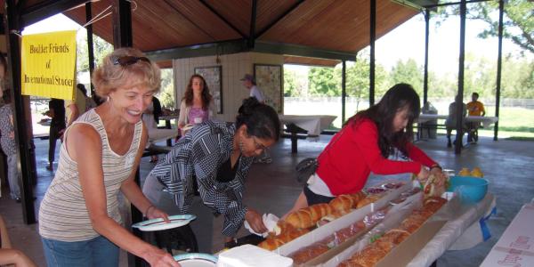 people making sandwiches in a gazebo