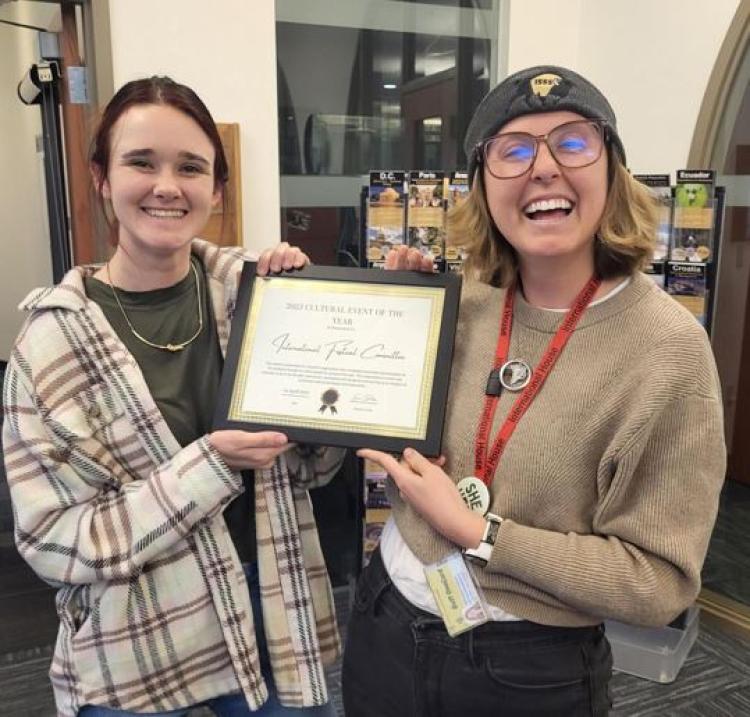 Tori Hoeninghausen and Miranda Fabian holding award