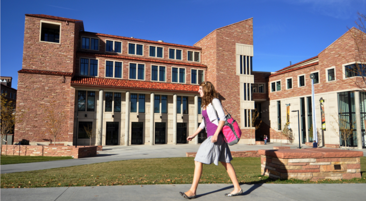 girl walking by building