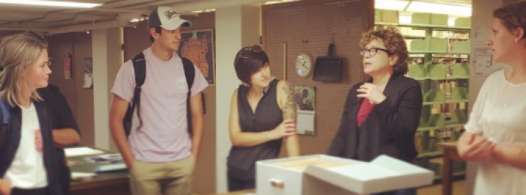 Students meeting with Professor Nan Goodman in the archives held in Norlin Library
