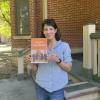 Kalisman holding copy of her book