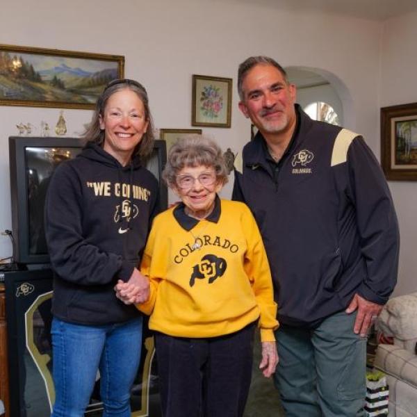 Gina LaFrazza, Peggy Coppom and Justin Schwartz celebrate the news of Coppom’s Chancellor’s Impact Award. (Patrick Campbell/University of Colorado)