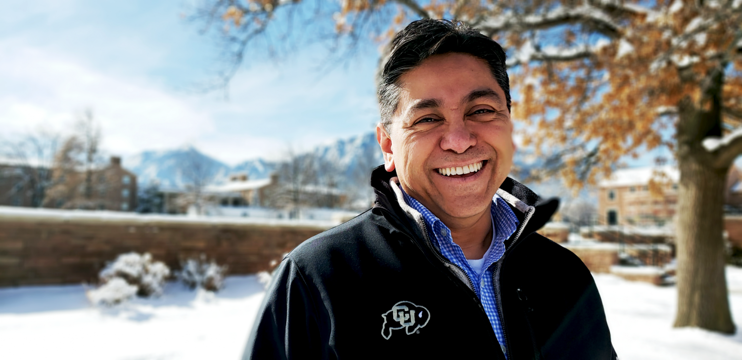 CU Boulder recruiter in front of Farrand Field.