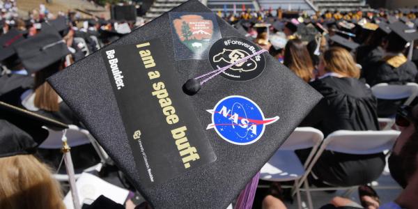 CU student at graduation in their cap. 