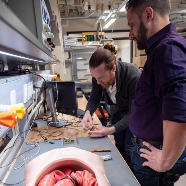Micah Prendergast and Greg Formosa working with the Endoculus Robot in the AMTL