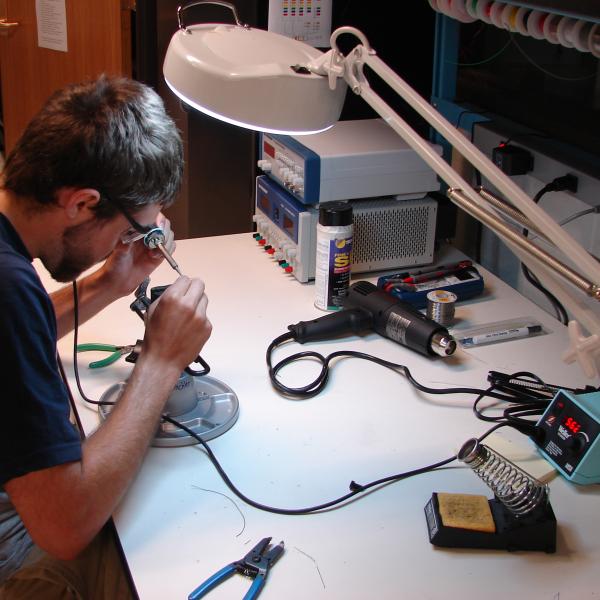 Levin working on electronics assembly.