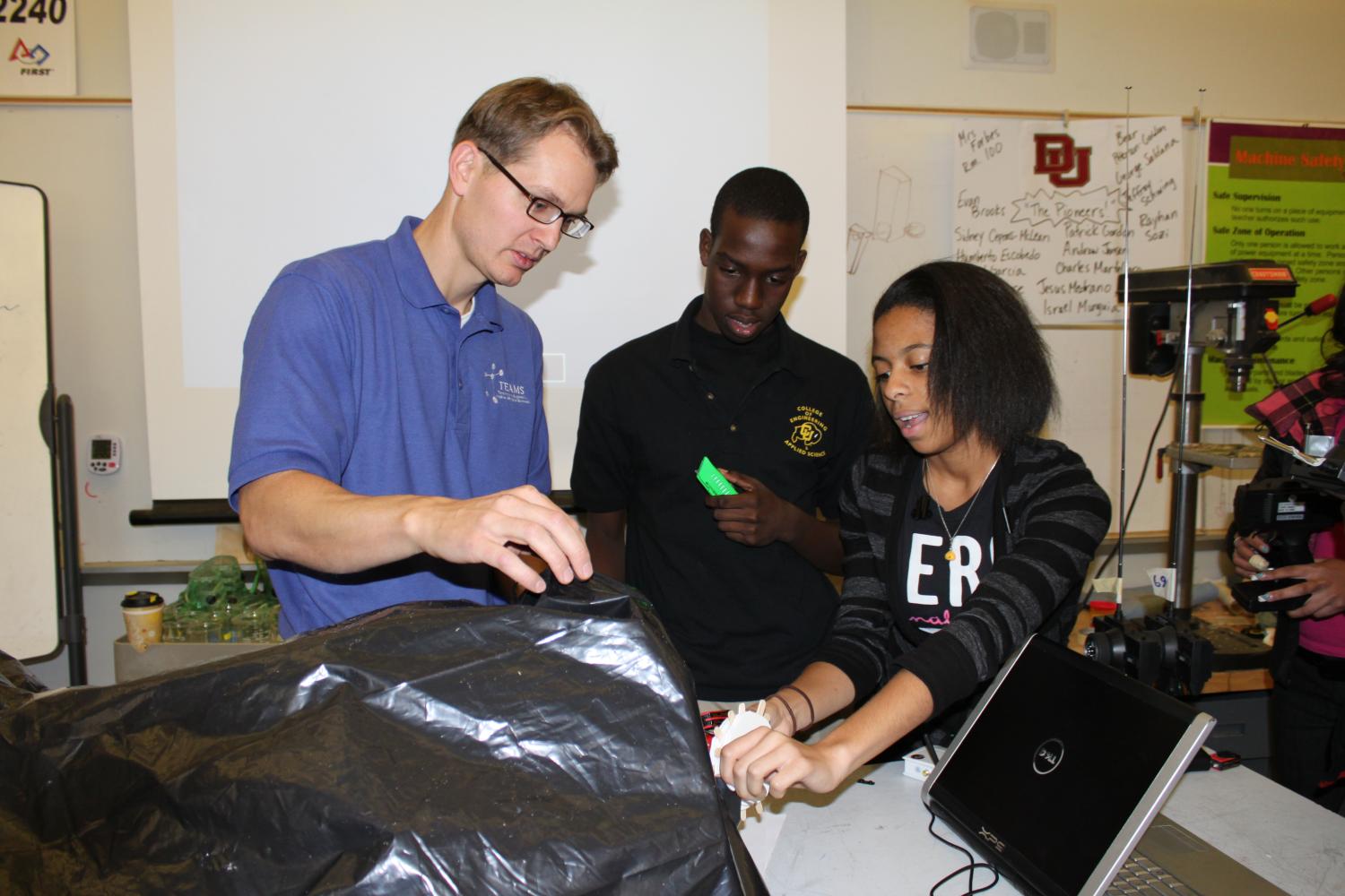 Ben Terry working with students using a surgical simulator