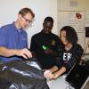 Ben Terry working with students using a surgical simulator