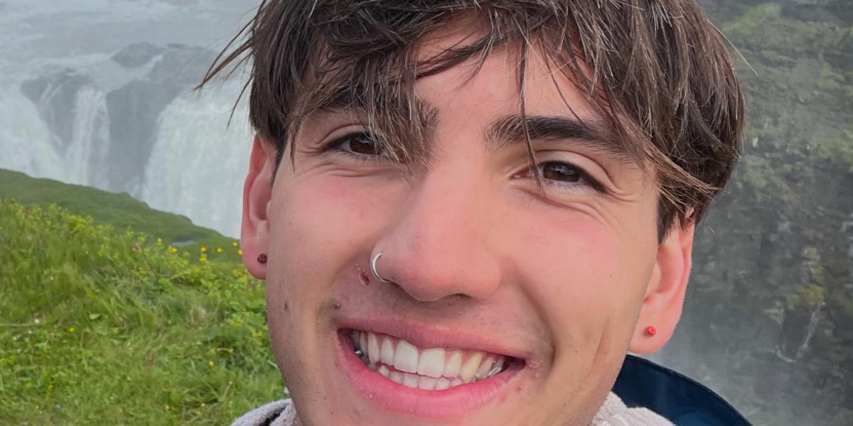 Aidan smiling in front of waterfalls